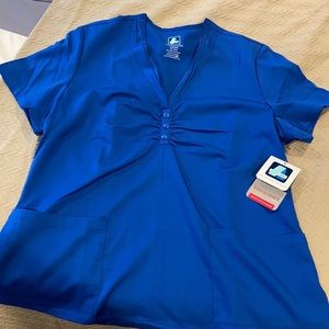 Woman’s blue scrub top with scarf neck detailing